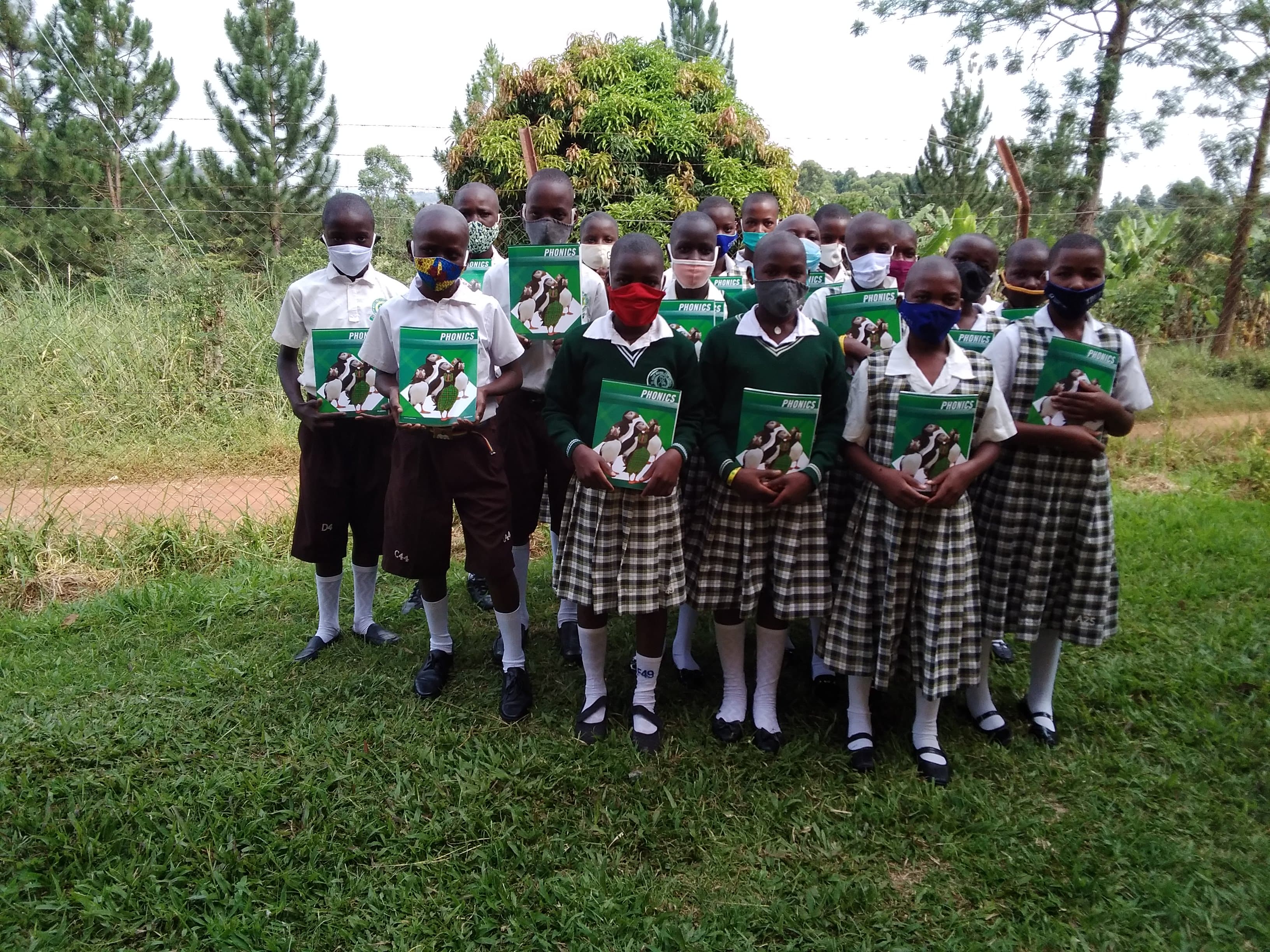 Boarding pupils holding their phonics books